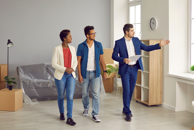 Couple taking tour of house with agent