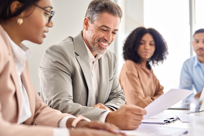Man looking at document with clients