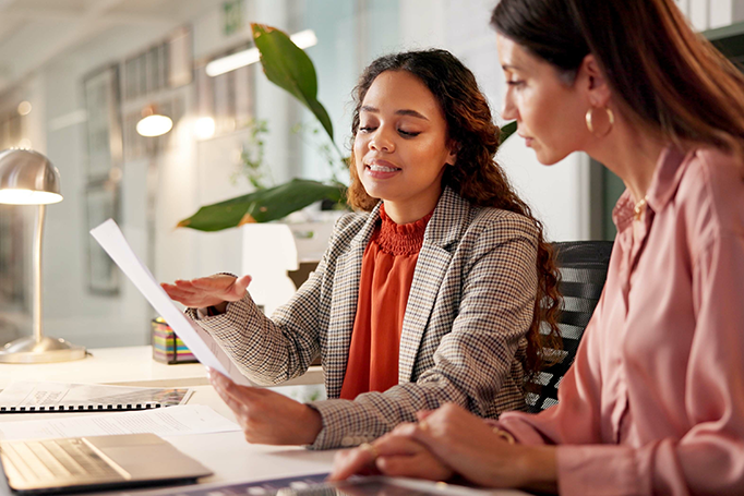 Woman looking over paperwork with client